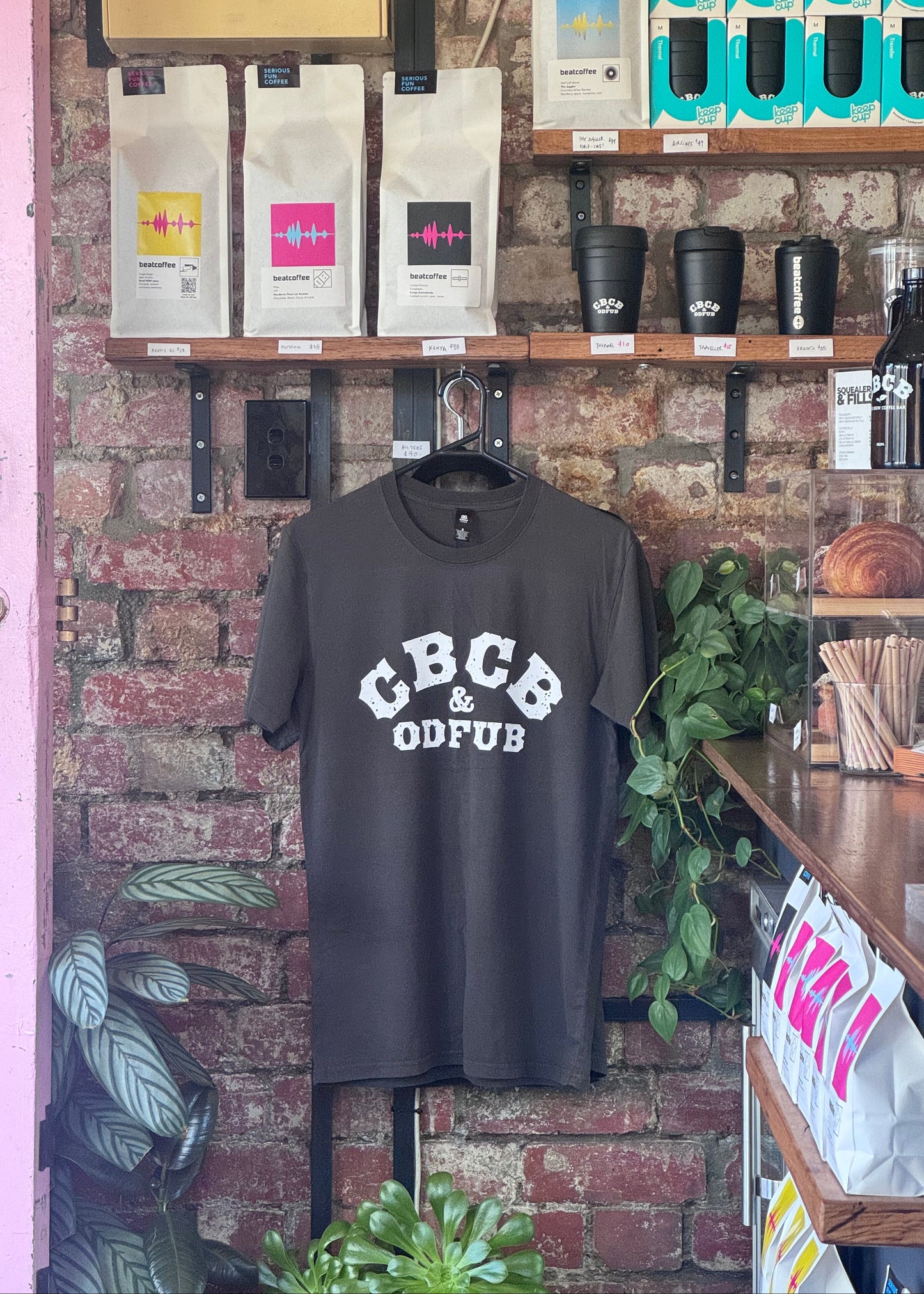 Faded black tee shirt with "CBCB & ODEFUB" in white print on chest